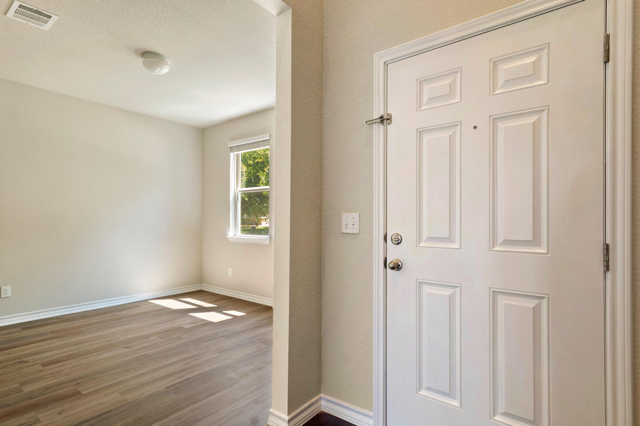 1341 Eagle Ray Street Leander, TX 78641 - Photo 10 of 37 A welcoming entry invites you into an airy living space with sun-drenched wood flooring.