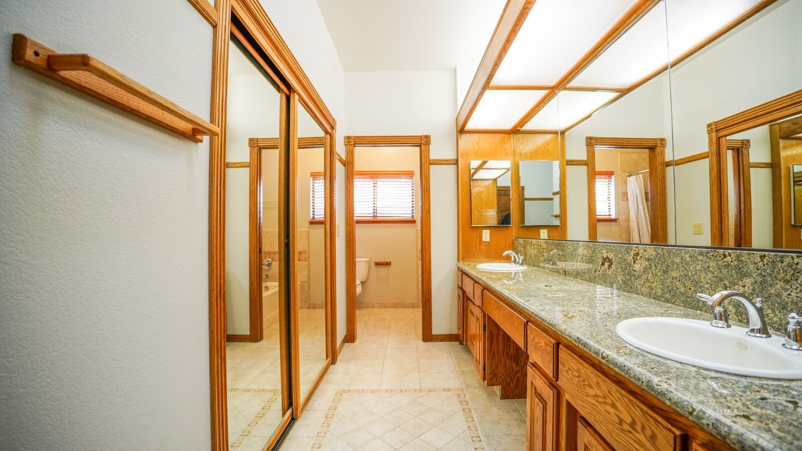 948 Hermosa Avenue Ridgecrest, CA 93555 - Photo 23 of 46 a bathroom with a granite countertop sink and a large mirror next to a window