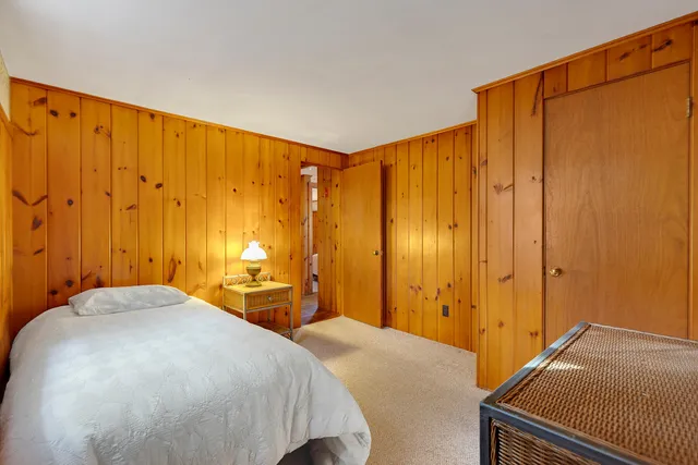 a bedroom with a bed and a closet