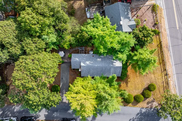 an aerial view of a house with a yard and garden