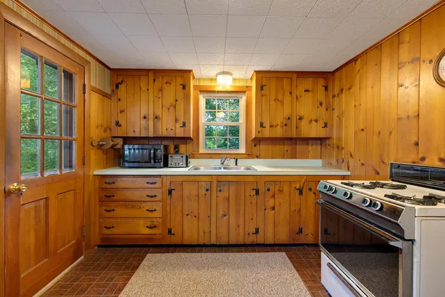 a kitchen with stainless steel appliances a stove and cabinets