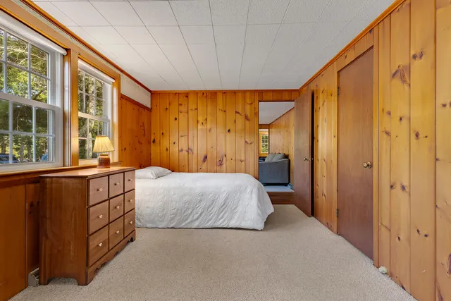 a bedroom with a bed and a large window