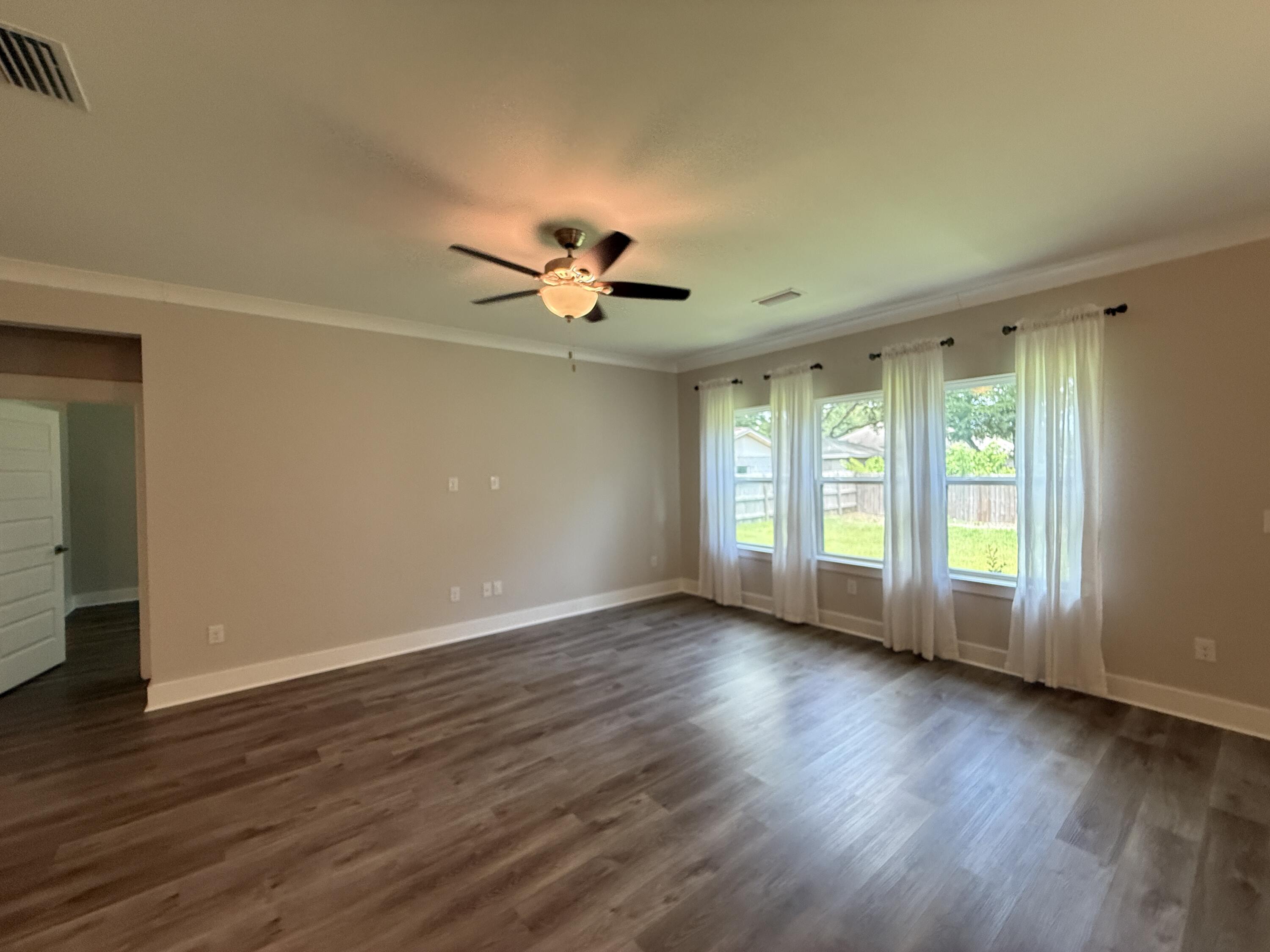 72 Wolverine Avenue Valparaiso, FL 32580 - Photo 16 of 20 a view of room with window ceiling fan and hardwood floor