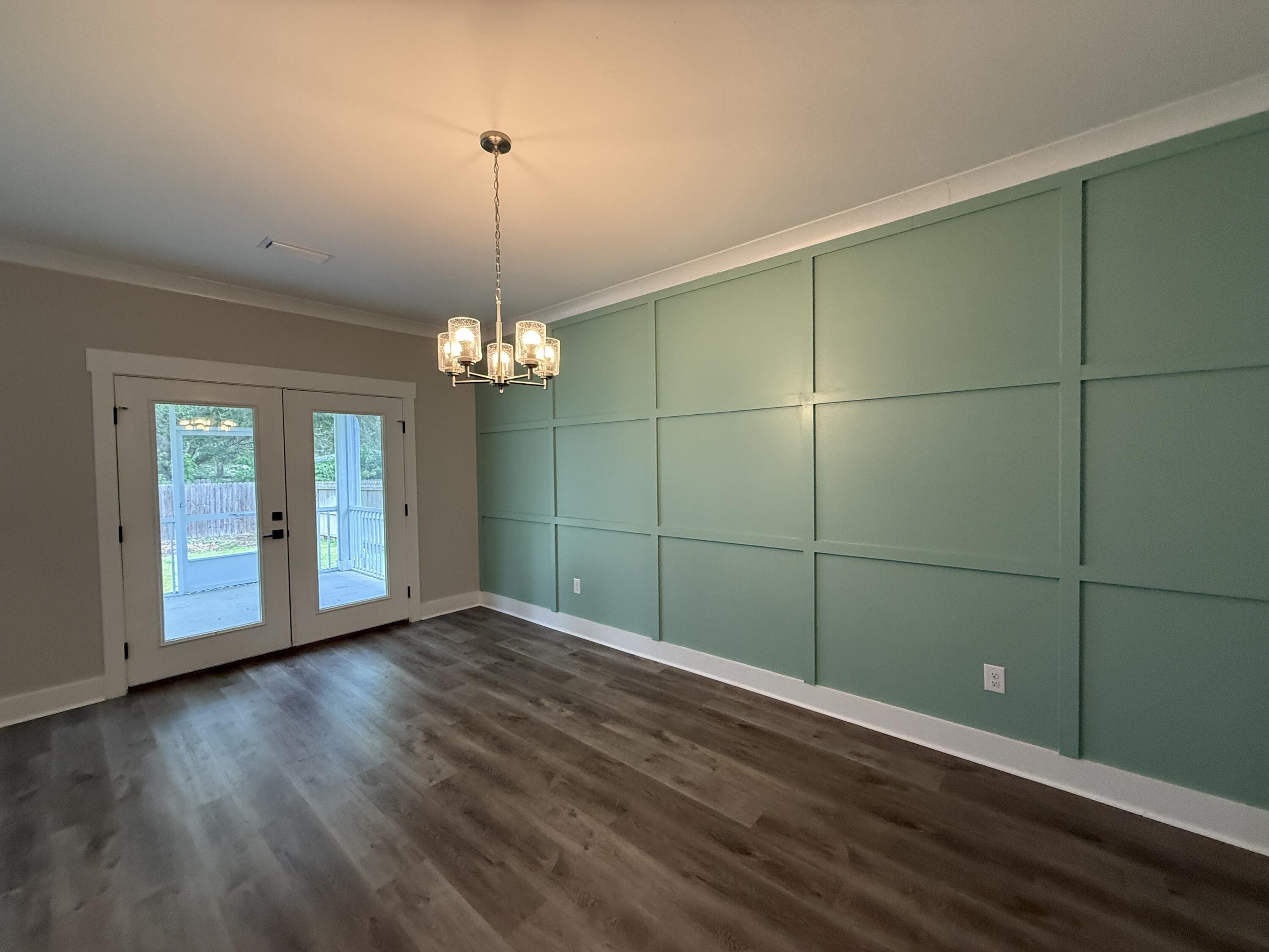 72 Wolverine Avenue Valparaiso, FL 32580 - Photo 18 of 20 an empty room with wooden floor and chandelier