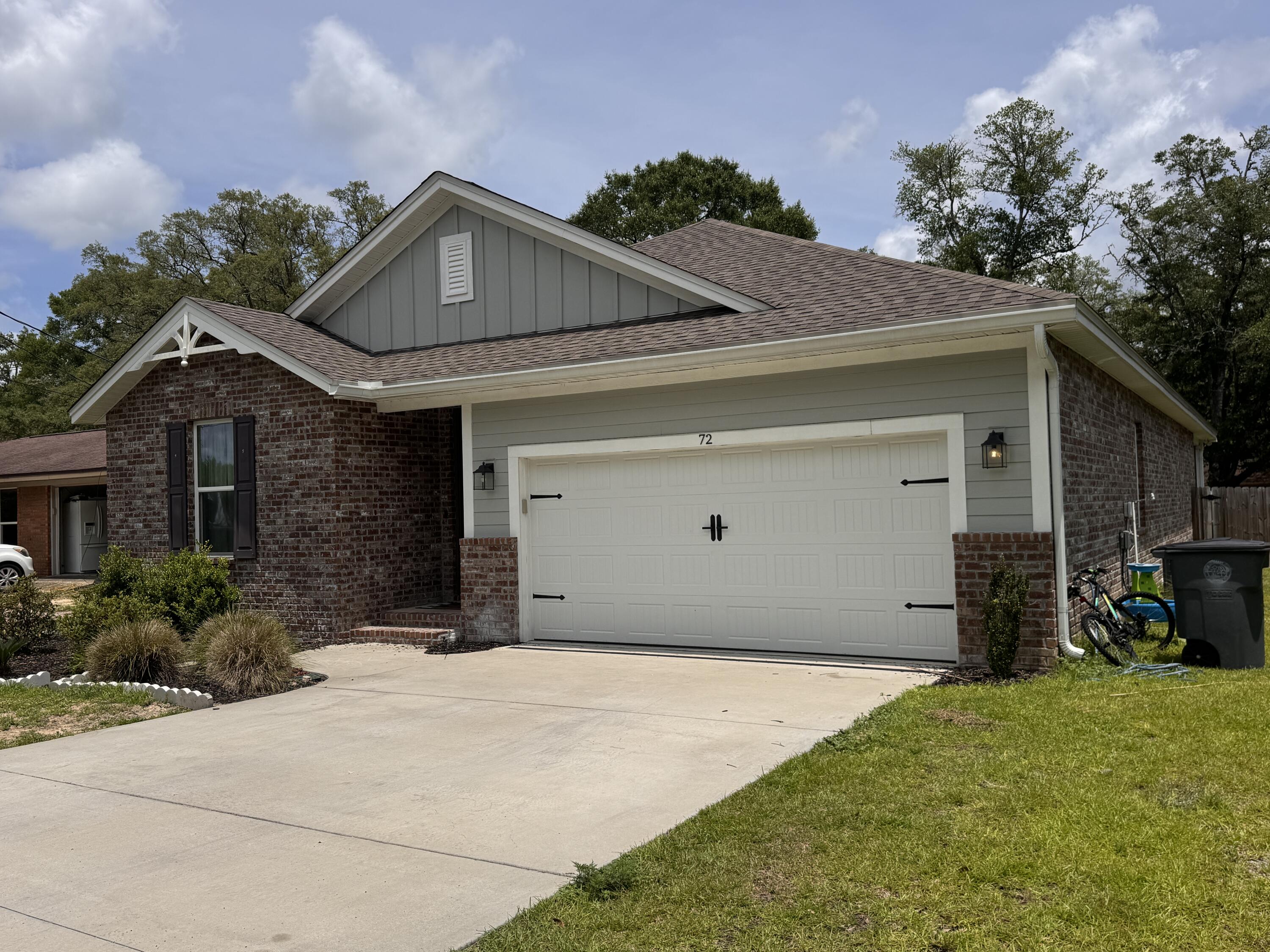 72 Wolverine Avenue Valparaiso, FL 32580 - Photo 3 of 20 a front view of a house with a yard and garage