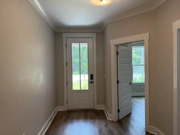 an empty room with wooden floor and a window