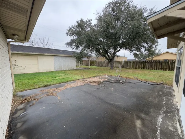 a view of a house with a yard and a garden