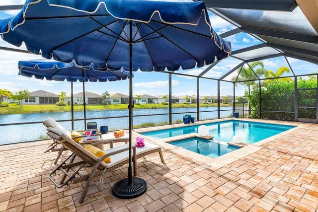 a view of a house with a yard and potted plants