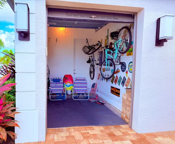 a living room with furniture chandelier and a large window