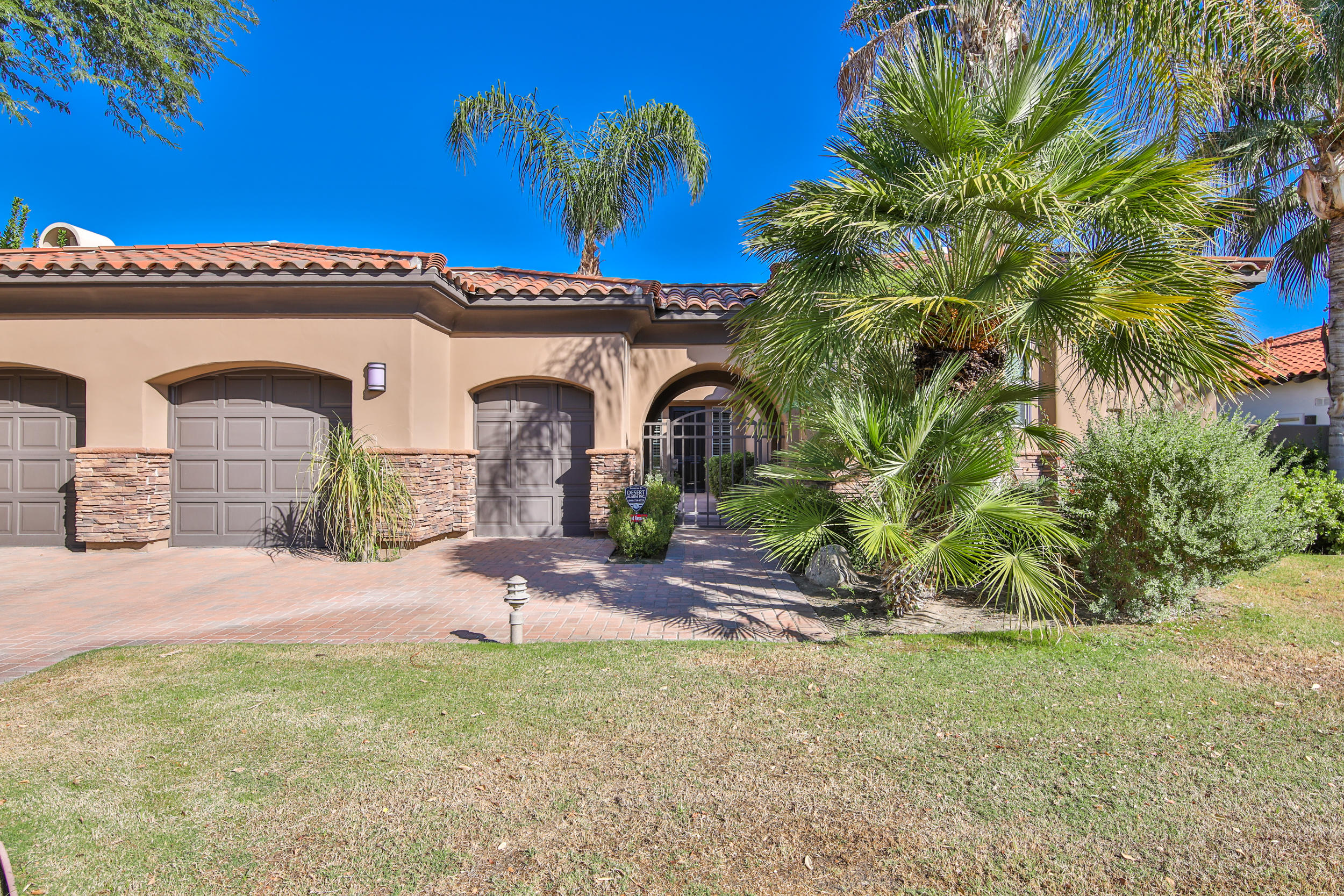 360 Loch Lomond Road Rancho Mirage, CA 92270 - Photo 2 of 76 a front view of a house with garden