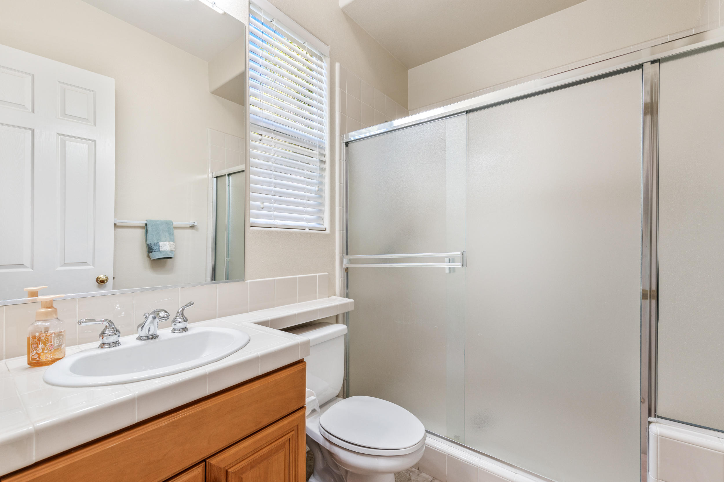 360 Loch Lomond Road Rancho Mirage, CA 92270 - Photo 12 of 76 a bathroom with a sink a mirror toilet and shower