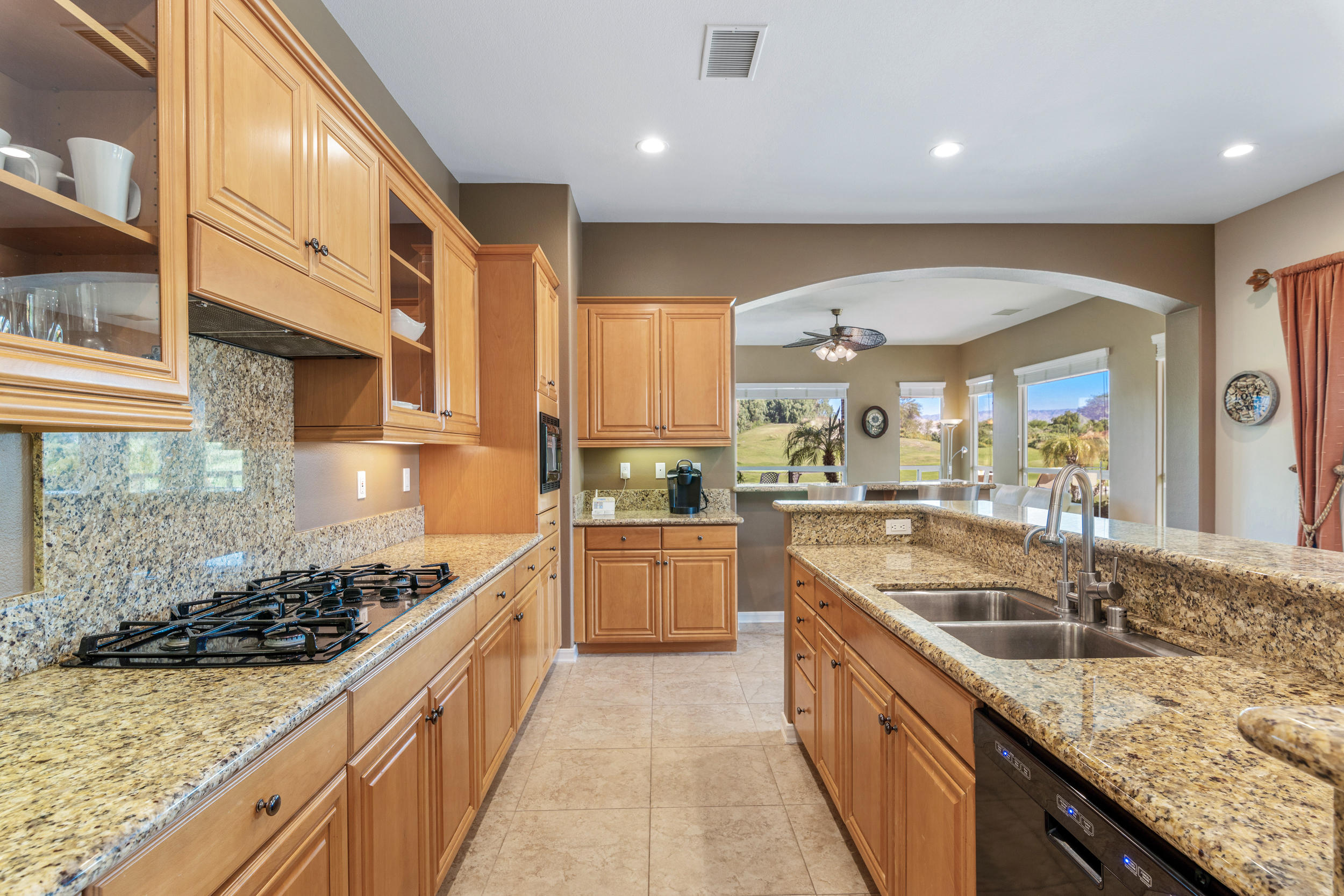 360 Loch Lomond Road Rancho Mirage, CA 92270 - Photo 15 of 76 a large kitchen with stainless steel appliances granite countertop a large stove a sink and a refrigerator
