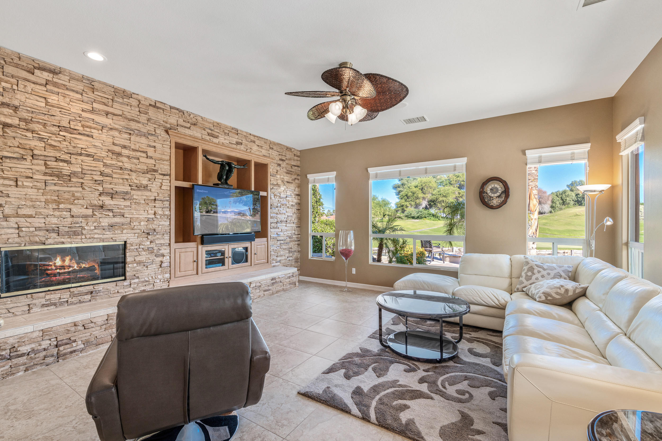 360 Loch Lomond Road Rancho Mirage, CA 92270 - Photo 18 of 76 a living room with furniture a fireplace and a flat screen tv