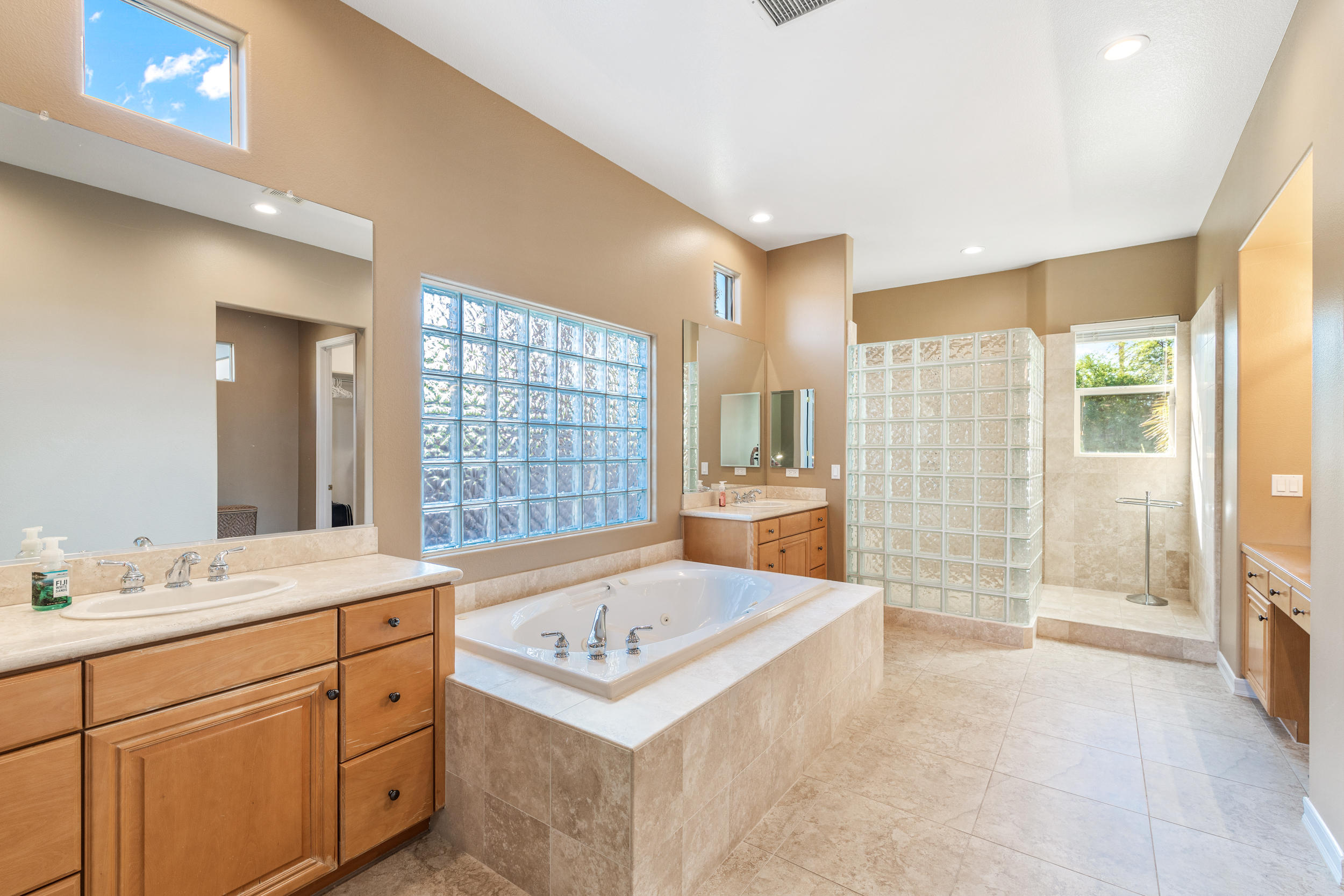 360 Loch Lomond Road Rancho Mirage, CA 92270 - Photo 26 of 76 a bathroom with a sink double vanity mirror and a bathtub