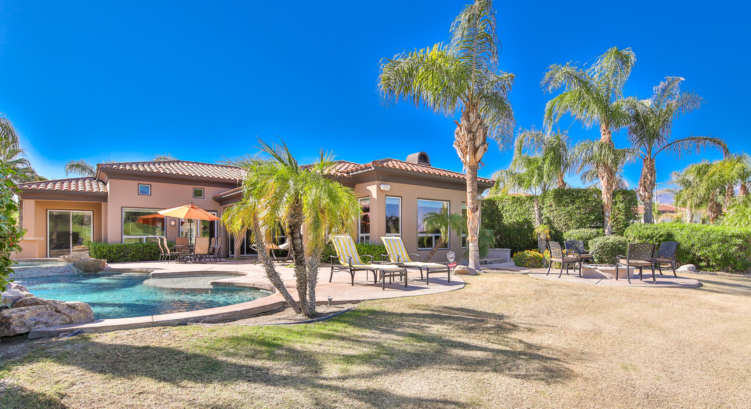 360 Loch Lomond Road Rancho Mirage, CA 92270 - Photo 44 of 76 a view of a building with a yard