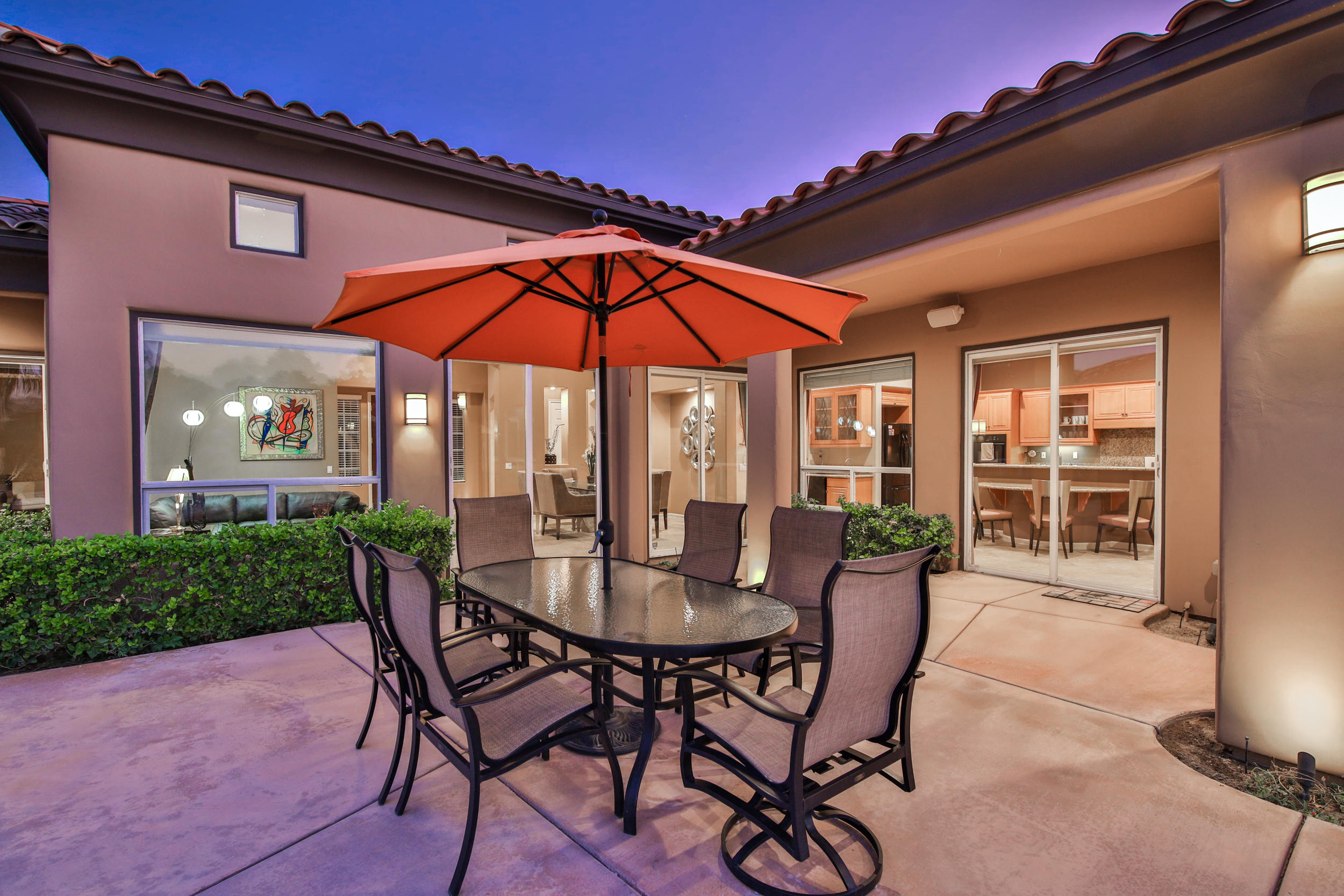 360 Loch Lomond Road Rancho Mirage, CA 92270 - Photo 54 of 76 a view of a patio with table and chairs under an umbrella