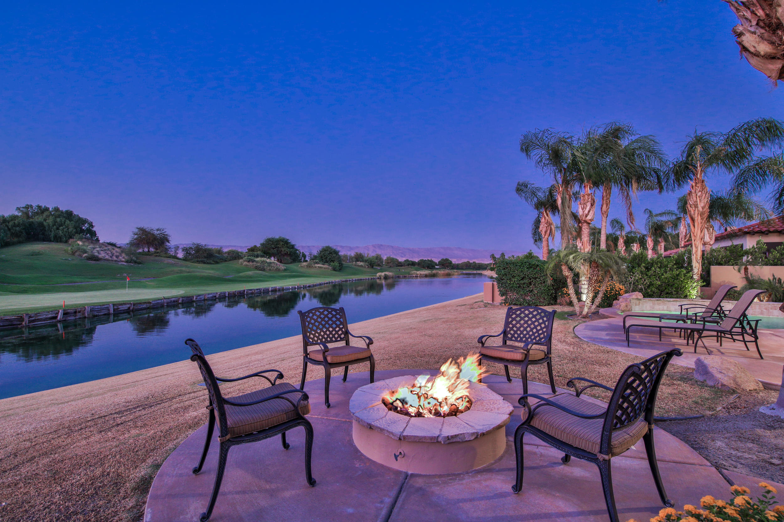 360 Loch Lomond Road Rancho Mirage, CA 92270 - Photo 62 of 76 a view of a patio with furniture and a fire pit