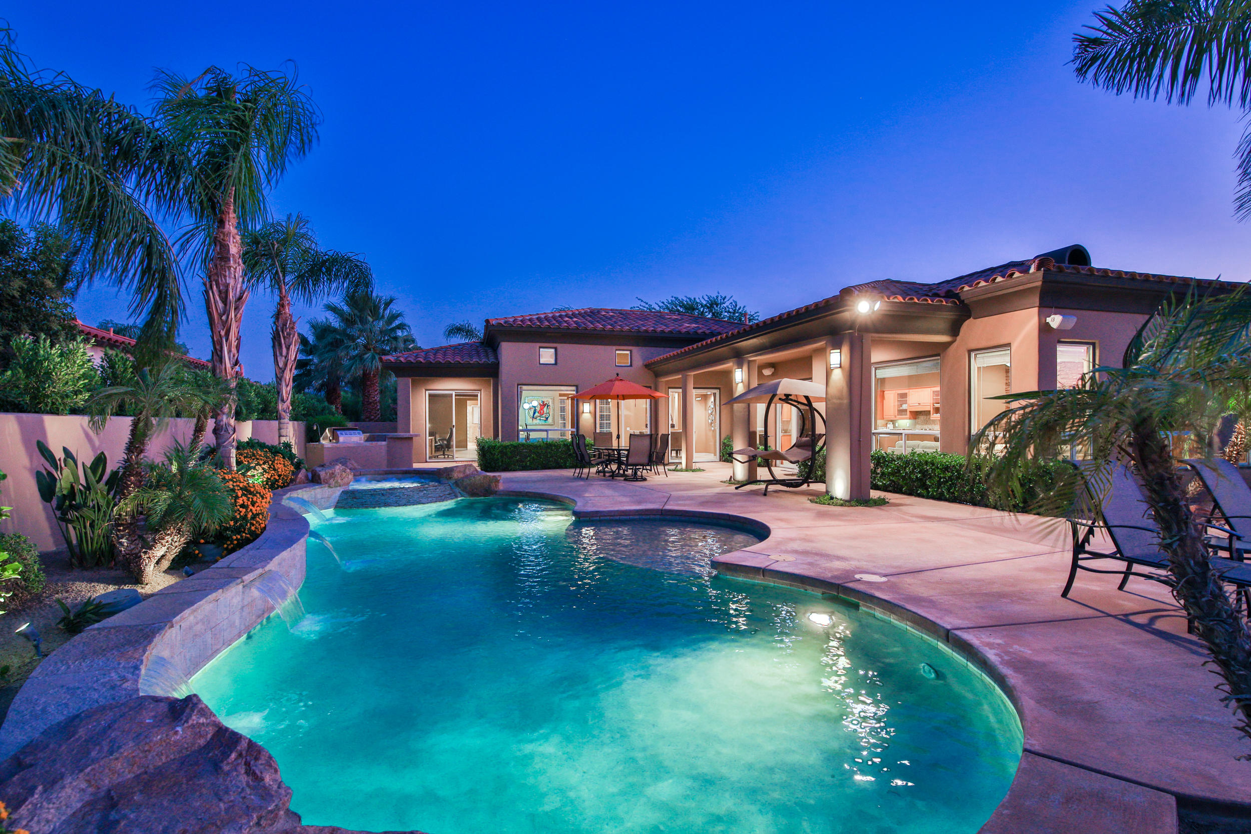 360 Loch Lomond Road Rancho Mirage, CA 92270 - Photo 65 of 76 a view of a house with swimming pool and sitting area