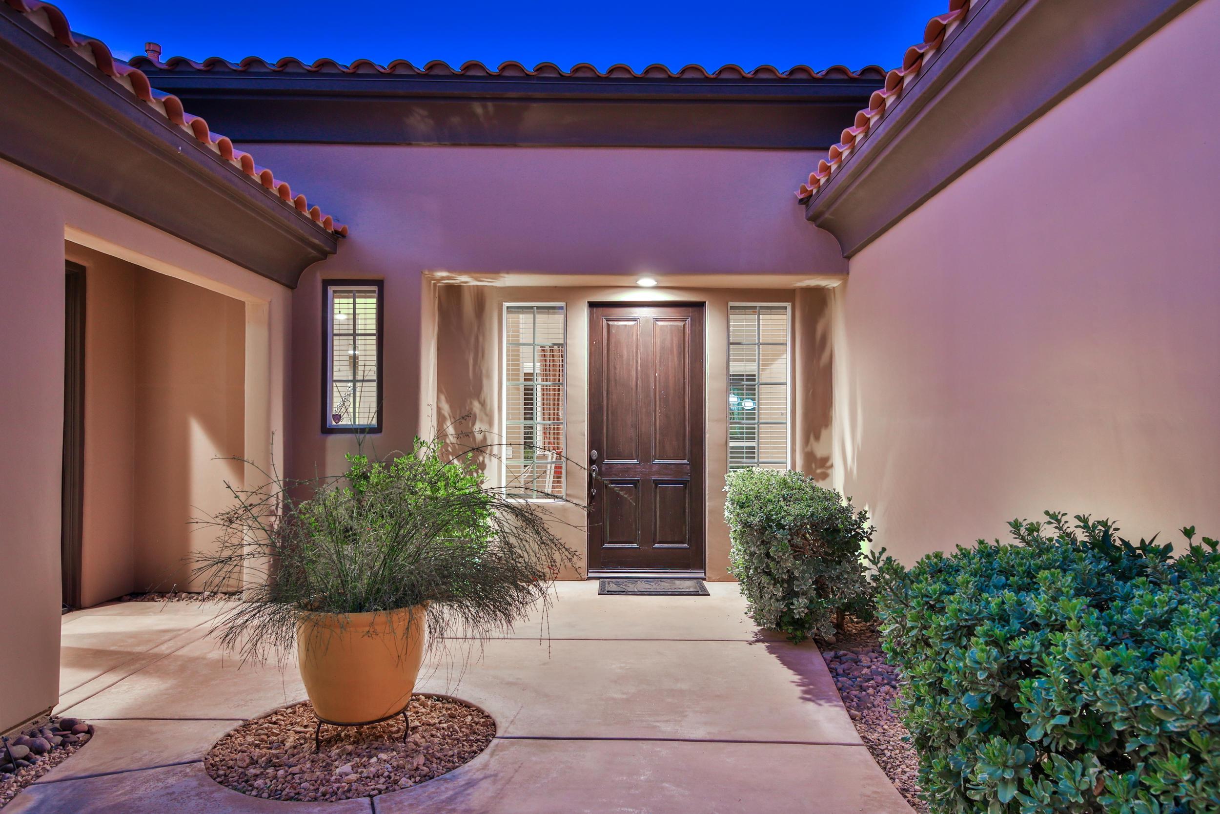 360 Loch Lomond Road Rancho Mirage, CA 92270 - Photo 67 of 76 a front view of a house with potted plants