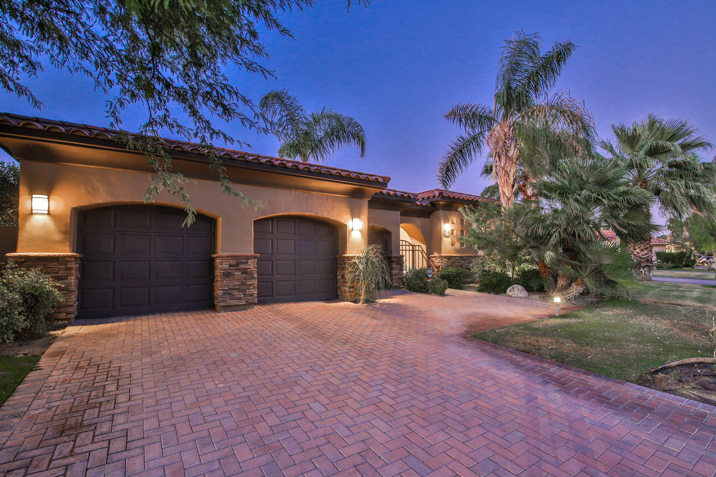 360 Loch Lomond Road Rancho Mirage, CA 92270 - Photo 69 of 76 a front view of a house with a yard and garage