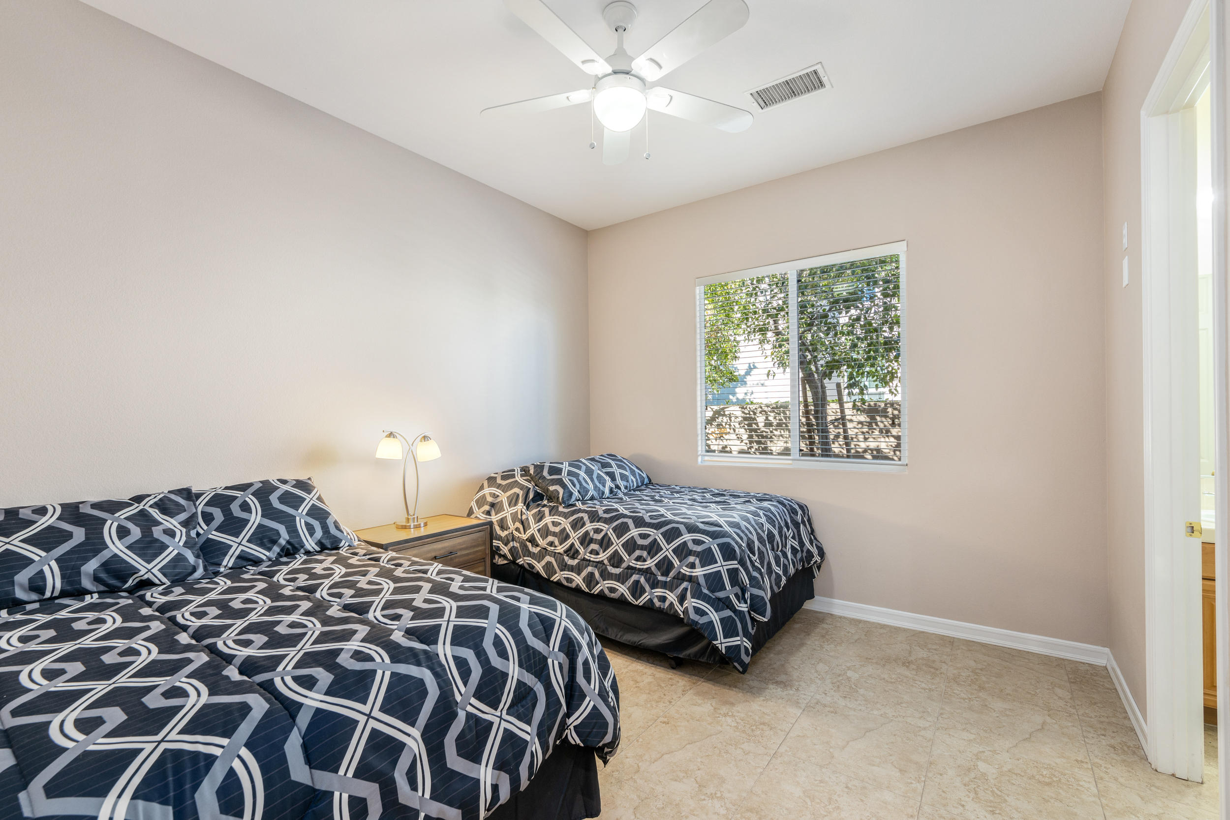 360 Loch Lomond Road Rancho Mirage, CA 92270 - Photo 10 of 76 a bedroom with two beds and a window