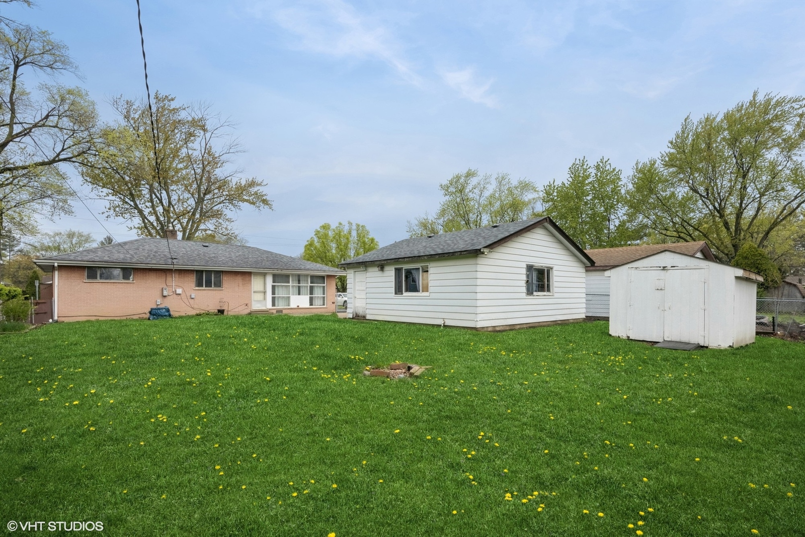 1425 North Wilke Road Arlington Heights, IL 60004 - Photo 11 of 12 a view of a house with a big yard potted plants and large tree