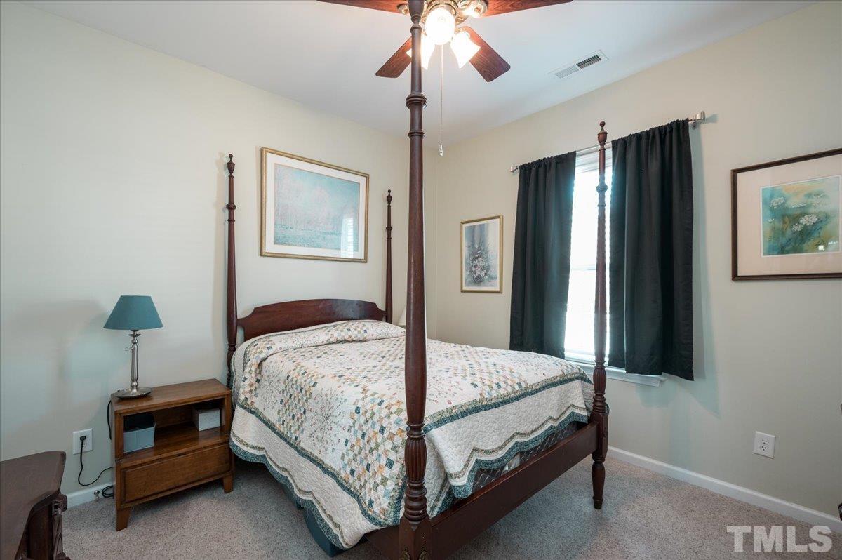 3900 Joe And Ruth Lee Drive Raleigh, NC 27610 - Photo 18 of 25 a bedroom with a bed and a chandelier