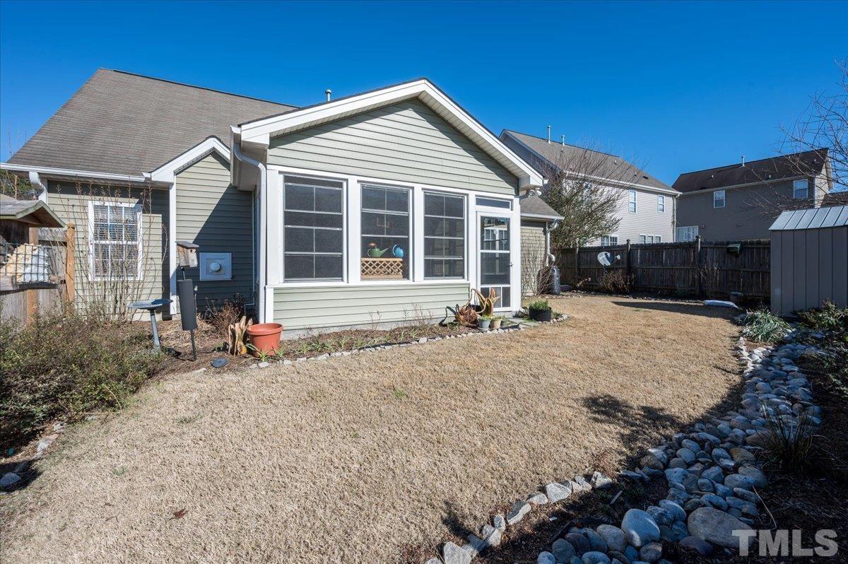 3900 Joe And Ruth Lee Drive Raleigh, NC 27610 - Photo 22 of 25 a front view of a house with a yard and garage