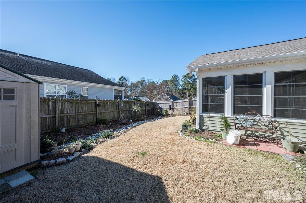 3900 Joe And Ruth Lee Drive Raleigh, NC 27610 - Photo 25 of 25 a view of a house with a floor to ceiling window and wooden fence