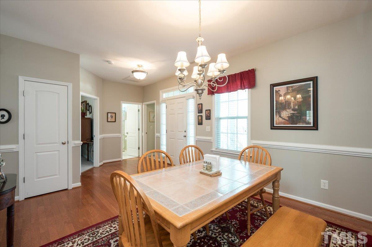 3900 Joe And Ruth Lee Drive Raleigh, NC 27610 - Photo 4 of 25 a view of a dining room with furniture and chandelier
