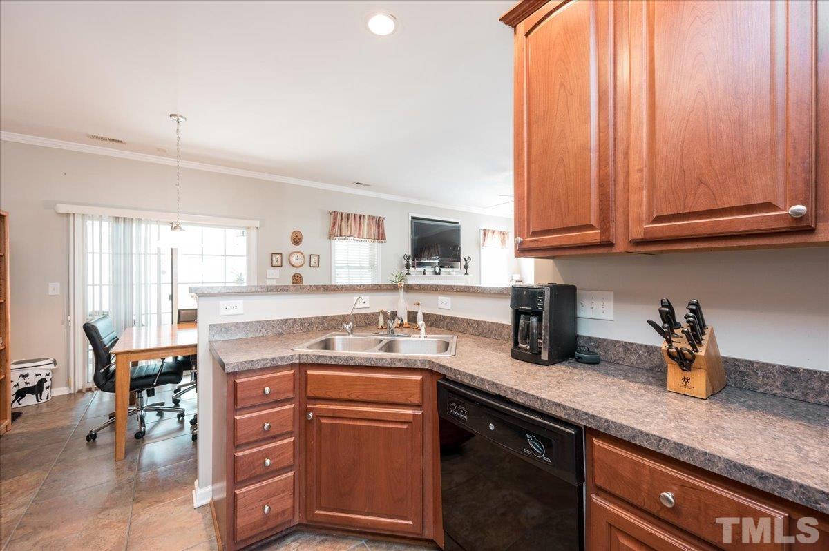 3900 Joe And Ruth Lee Drive Raleigh, NC 27610 - Photo 5 of 25 a kitchen with a sink a stove cabinets and a window
