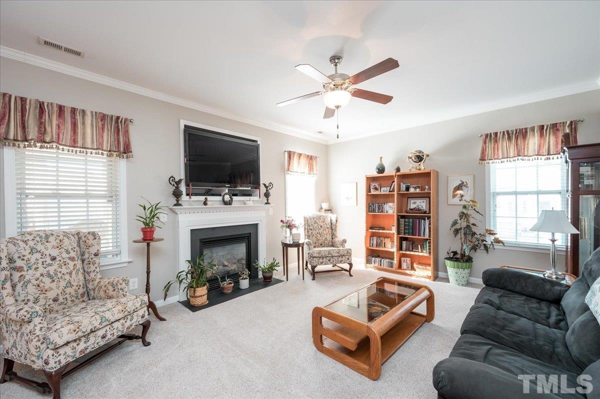 3900 Joe And Ruth Lee Drive Raleigh, NC 27610 - Photo 10 of 25 a living room with furniture a fireplace and a flat screen tv