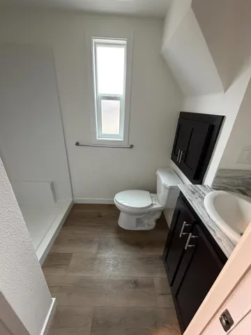 a bathroom with a toilet sink and mirror