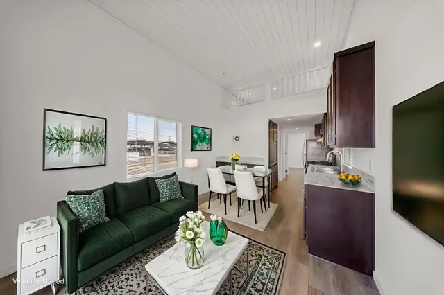 a living room with furniture a rug and a flat screen tv