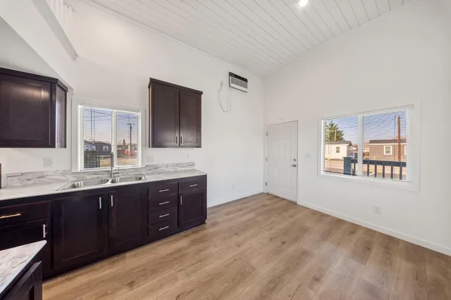 a spacious bathroom with a granite countertop double vanity sink and mirror