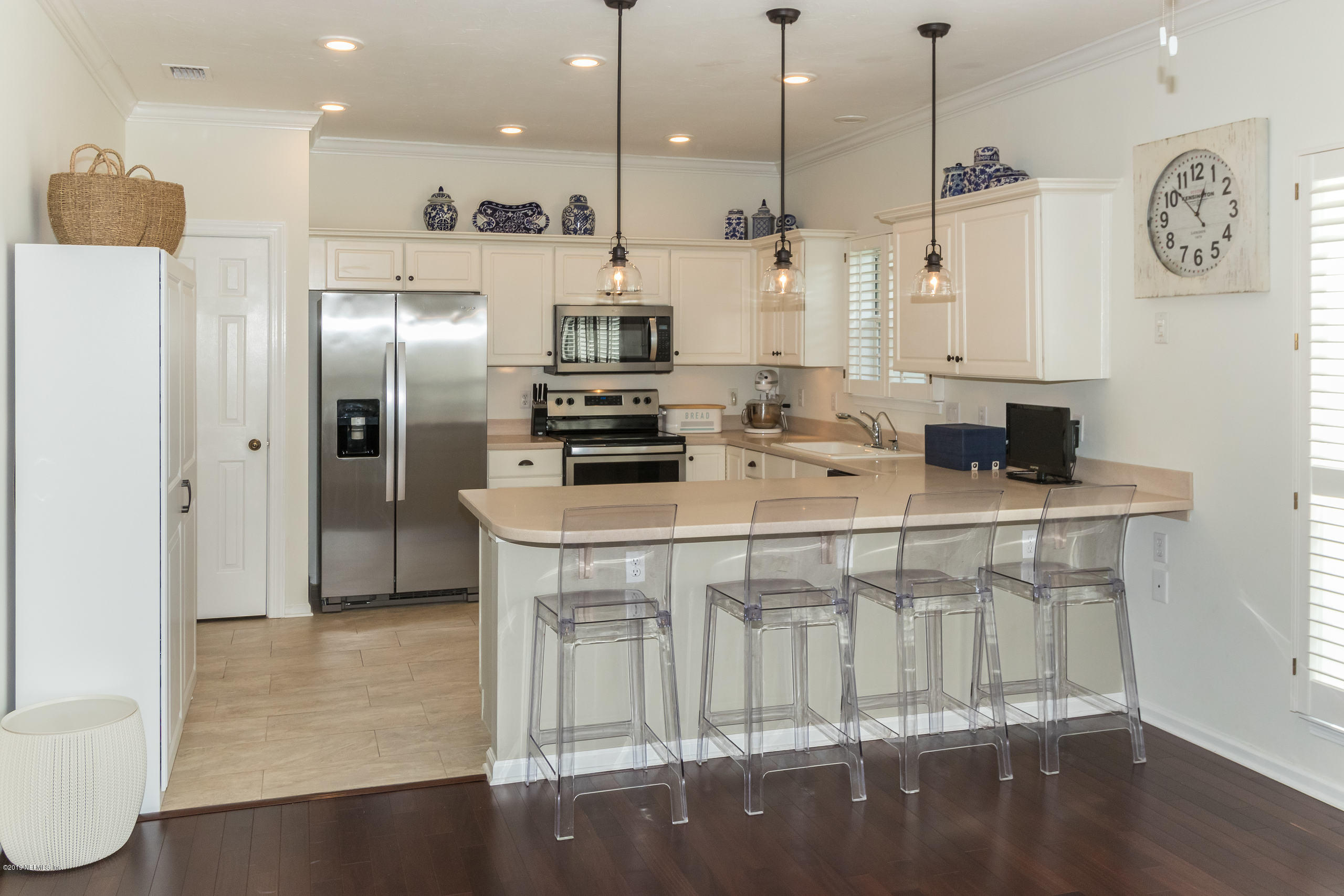 601 Teeside Court St. Augustine, FL 32080 - Photo 13 of 38 a kitchen with stainless steel appliances kitchen island granite countertop a stove a refrigerator a oven a sink with a dining table and chairs