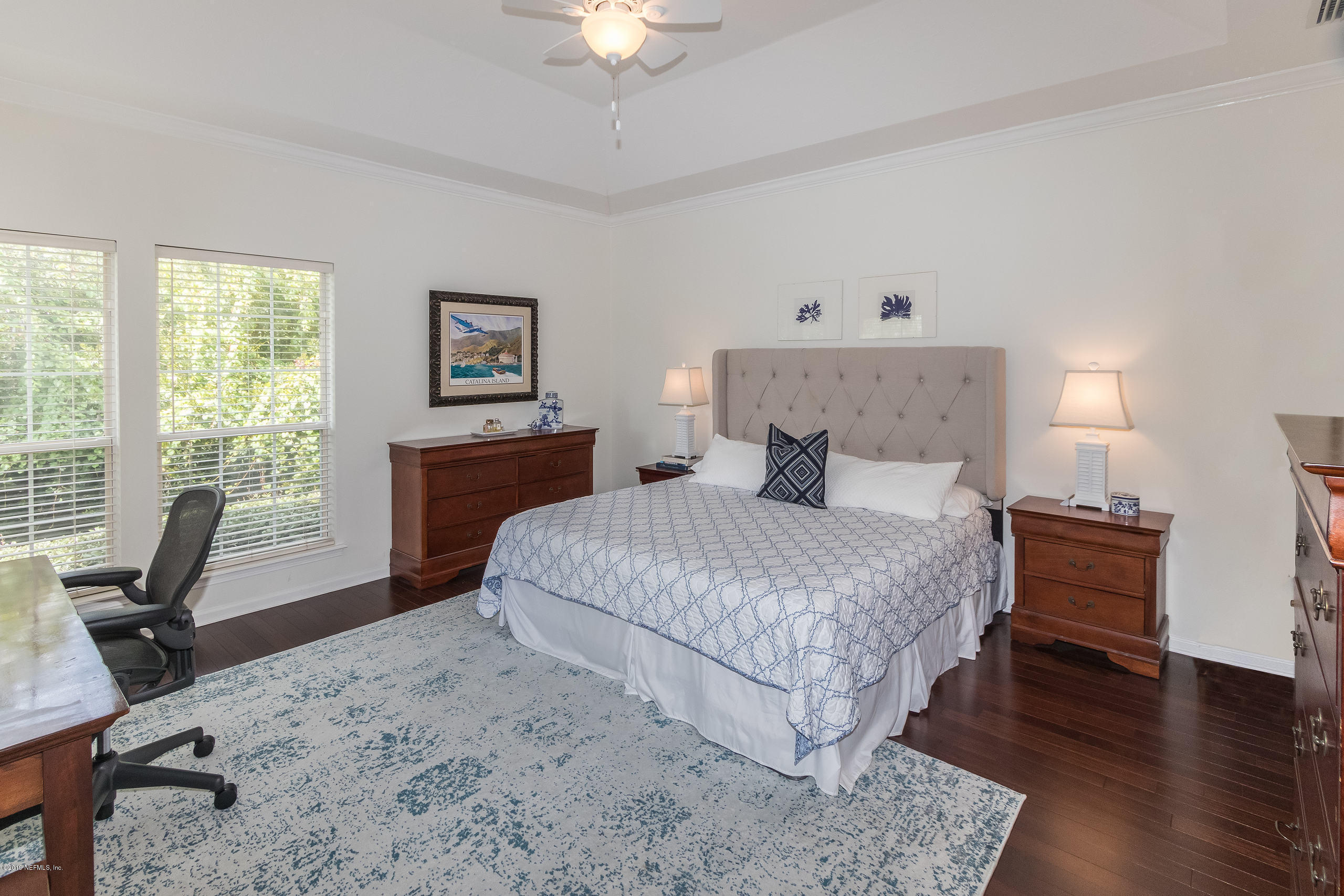 601 Teeside Court St. Augustine, FL 32080 - Photo 16 of 38 a bedroom with a bed a table and a chandelier