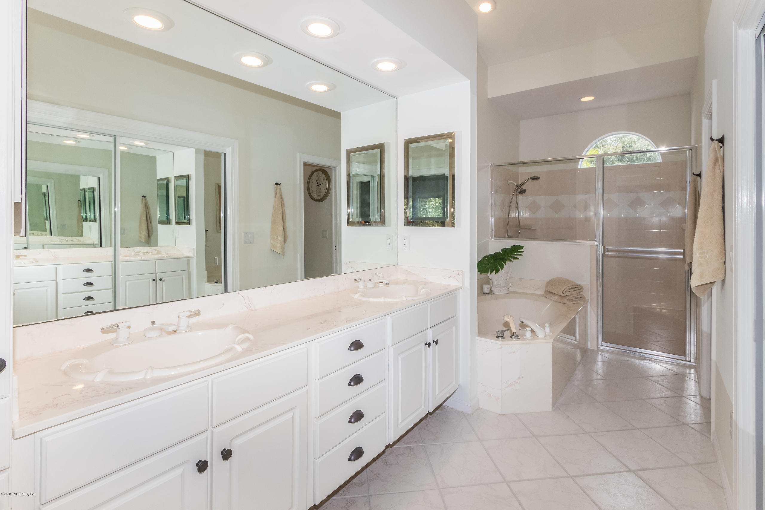 601 Teeside Court St. Augustine, FL 32080 - Photo 18 of 38 a spacious bathroom with a granite countertop sink a mirror and shower