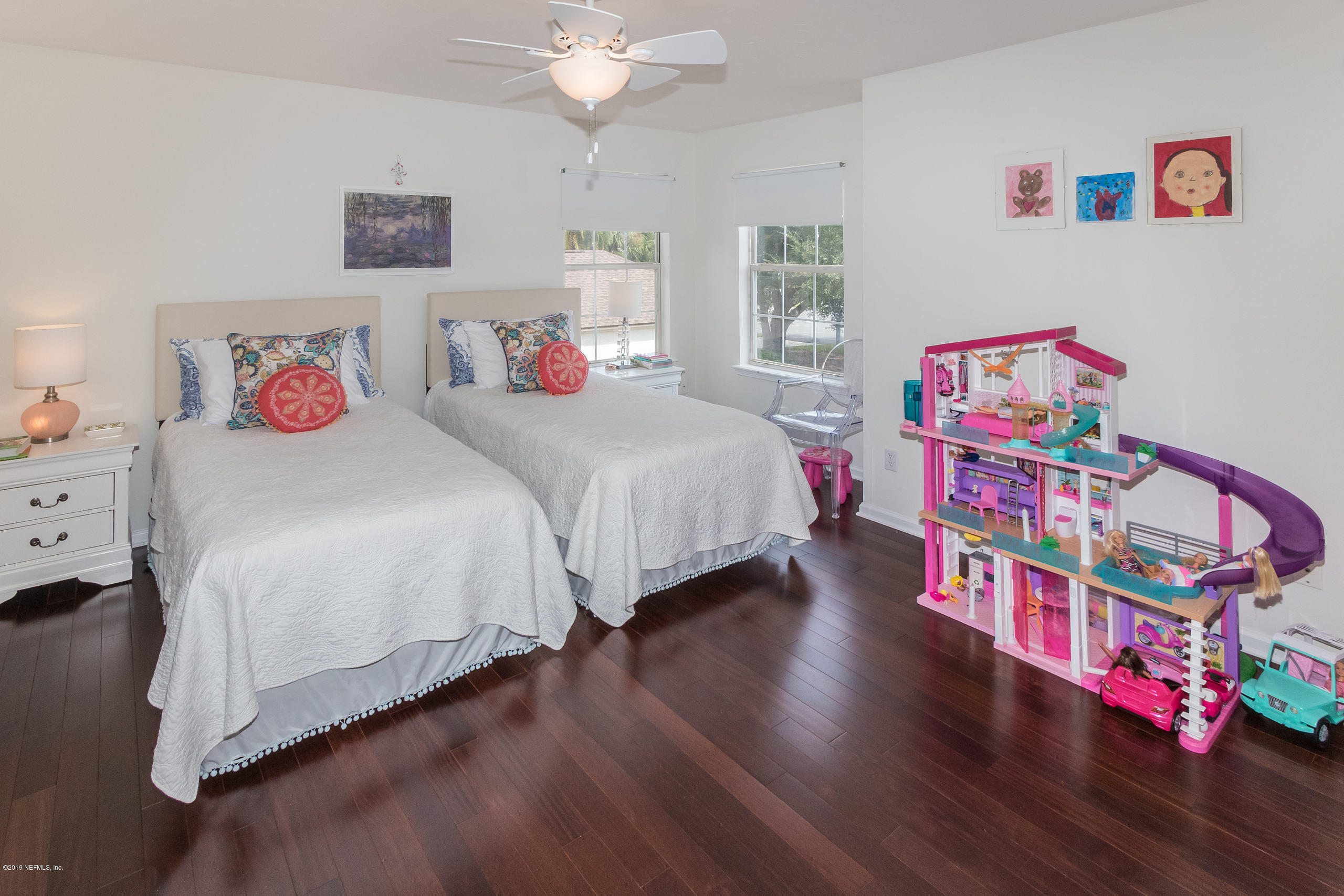 601 Teeside Court St. Augustine, FL 32080 - Photo 21 of 38 a bedroom with a bed and a chandelier