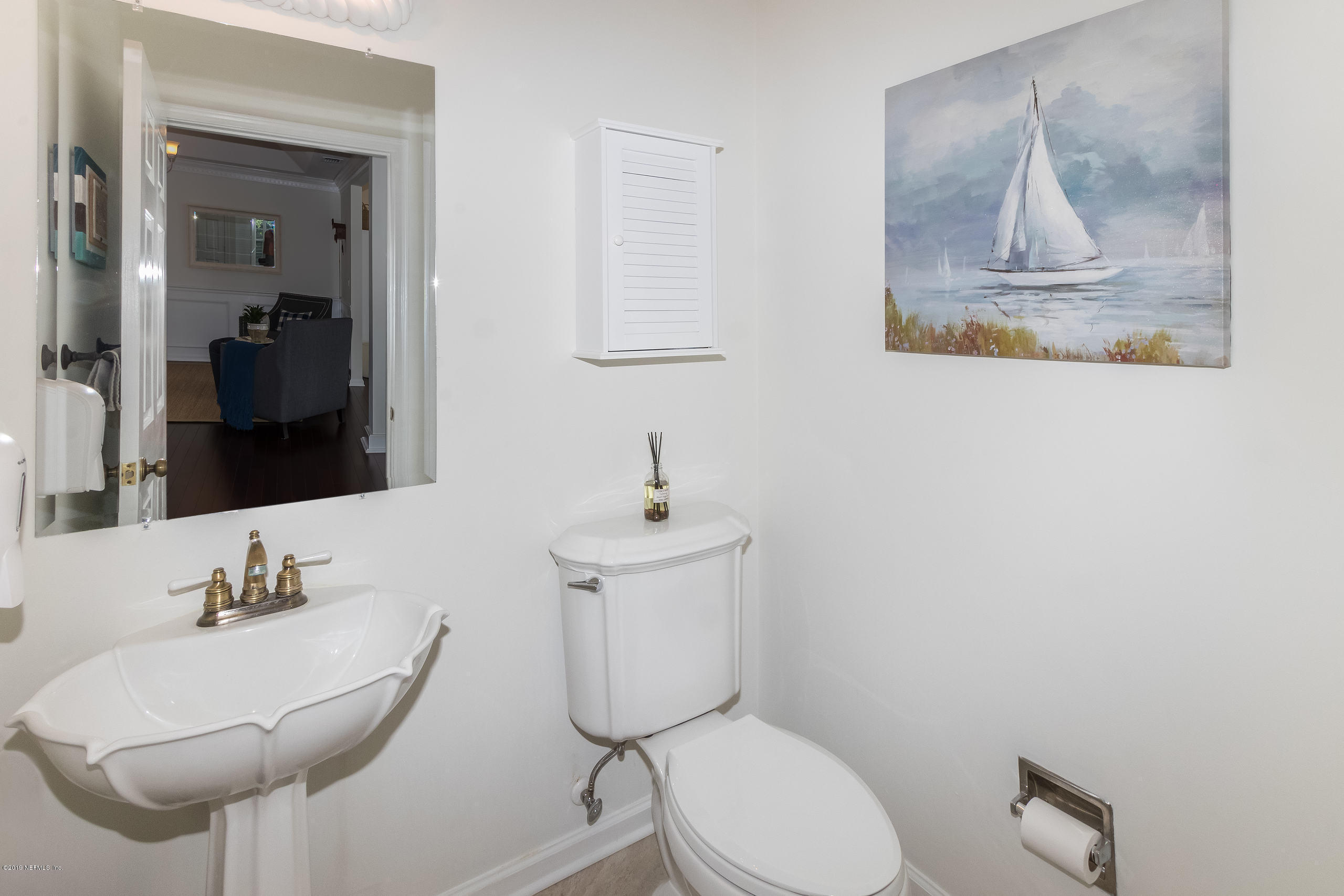 601 Teeside Court St. Augustine, FL 32080 - Photo 25 of 38 a bathroom with a toilet sink and mirror
