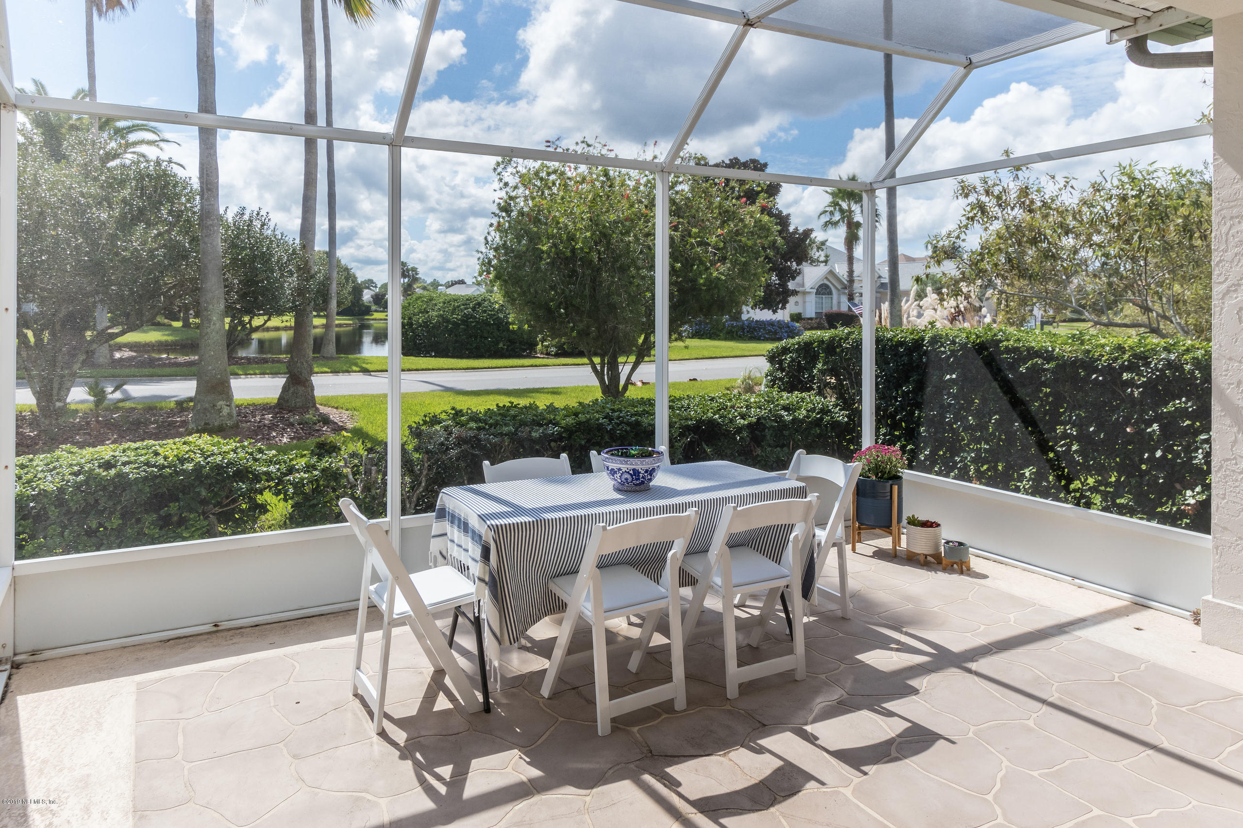 601 Teeside Court St. Augustine, FL 32080 - Photo 30 of 38 a view of a patio with a table chairs and a small yard