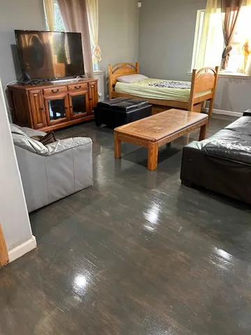 a kitchen with stainless steel appliances kitchen island granite countertop a table chairs sink and cabinets