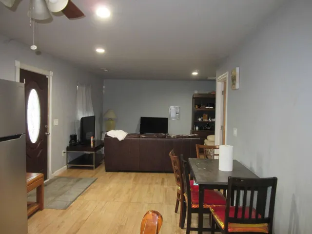 a bedroom with furniture and a wooden floor