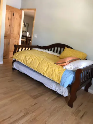 a bedroom with a bed and dresser