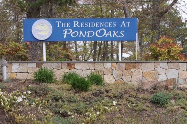 196 Winstead Road Brewster, MA 02631 - Photo 3 of 6 a view of outdoor space with signage and flags