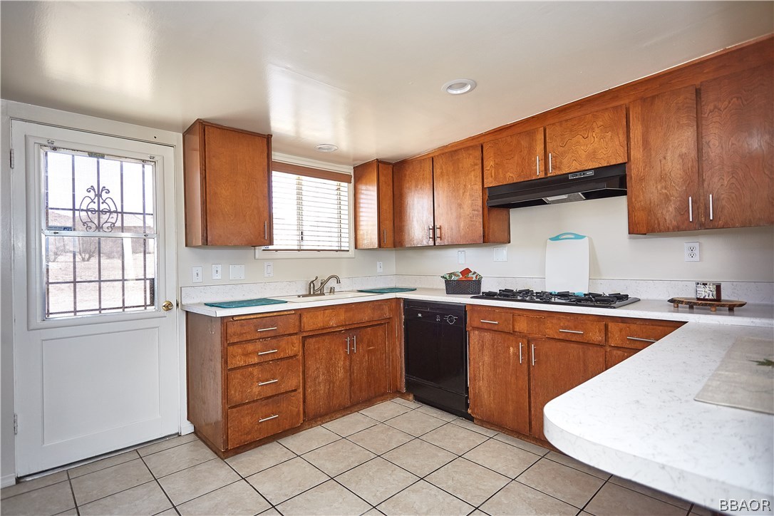19616 Huasna Road Apple Valley, CA 92307 - Photo 12 of 48 a kitchen with stainless steel appliances granite countertop a sink and cabinets