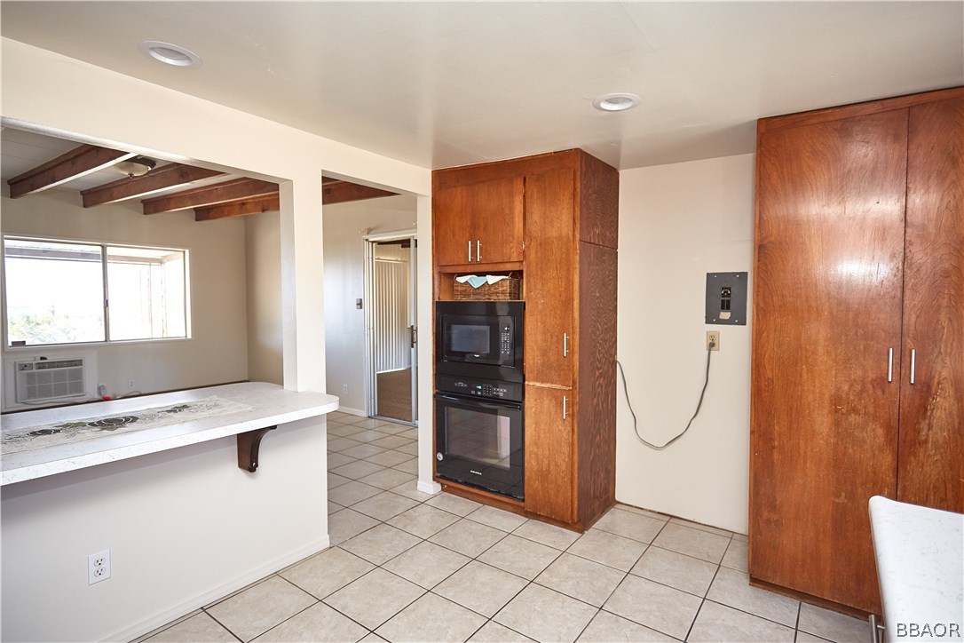 19616 Huasna Road Apple Valley, CA 92307 - Photo 14 of 48 a view of a kitchen with refrigerator and mirror
