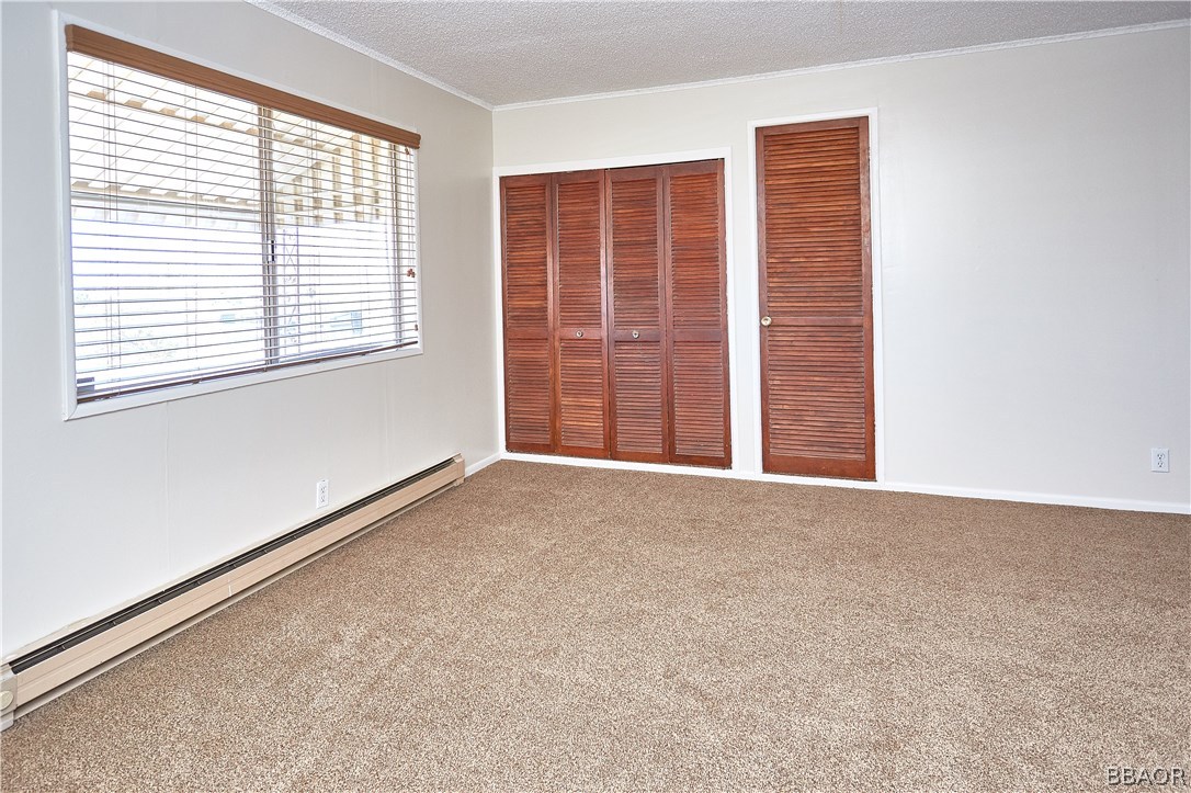19616 Huasna Road Apple Valley, CA 92307 - Photo 22 of 48 a view of an empty room with a window