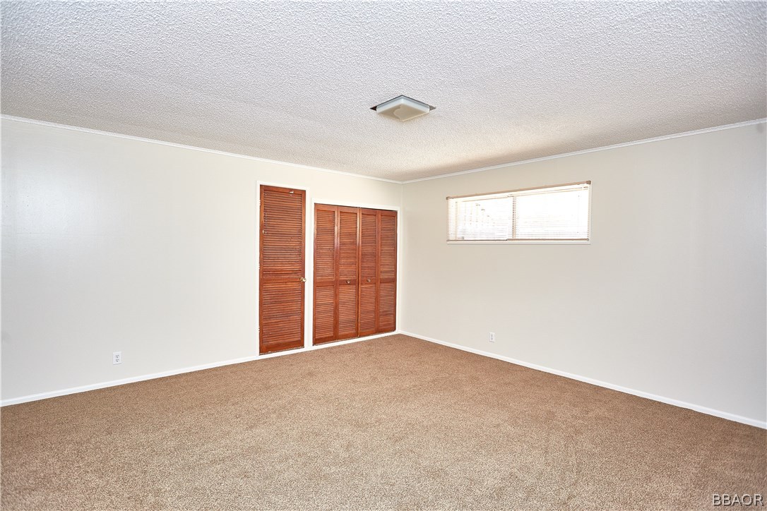 19616 Huasna Road Apple Valley, CA 92307 - Photo 26 of 48 a view of an empty room with a window
