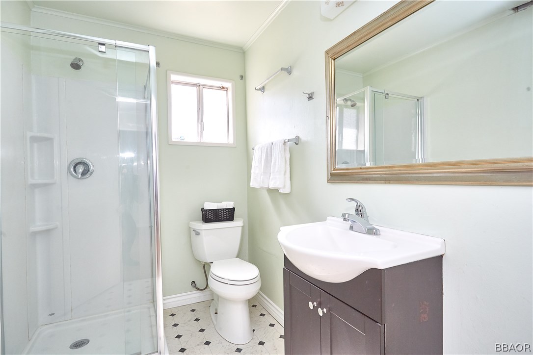 19616 Huasna Road Apple Valley, CA 92307 - Photo 28 of 48 a bathroom with a sink toilet a mirror and shower